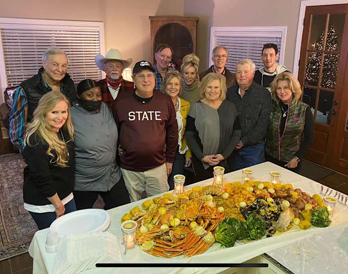 Mike Leach and friends pose for a photo with Starkville restaurant owner Shan Suber at a catering event at his home.